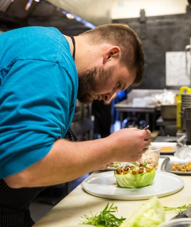 Chef Ross Warhol working on a dish